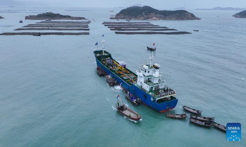 This aerial photo taken on Nov. 25, 2022 shows a transport vessel carring abalones on the waters of Lianjiang County, southeast China's Fujian Province. Abalone breeding is one of the pillar industries in Lianjiang County. As abalones have very strict requirements on their growing environment, especially the water temperature, fishermen in Lianjiang have adopted a way of breeding in different sea areas to improve the survival rate of abalones.