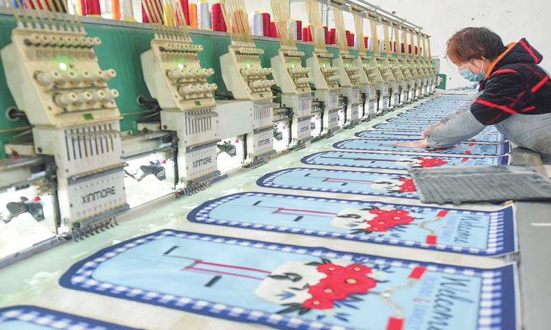 A worker embroiders export orders at a factory in Donghai county, East China's Jiangsu Province on November 27, 2022. Since the beginning of the year, Donghai has been stepping up production to meet demand from markets along the Belt and Road  Initiative route.Photo:cnsphoto
