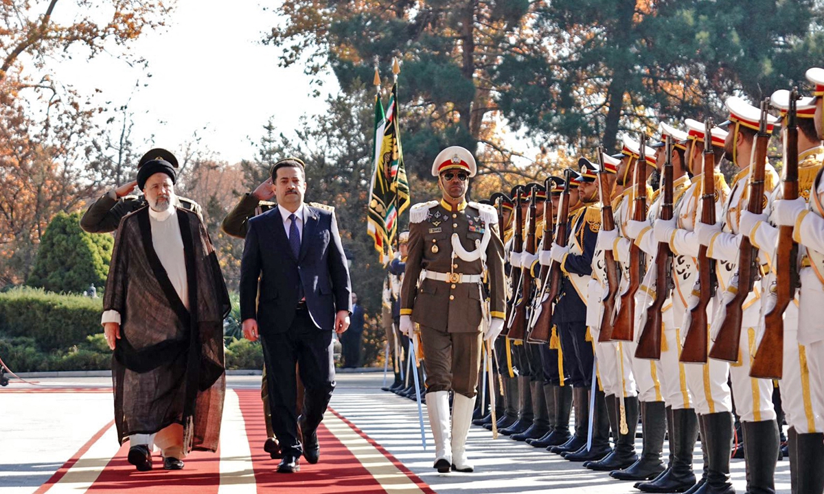 Iraqi Prime Minister Mohamed Shia al-Sudani (second left) and Iran's President Ebrahim Raisi (left) inspect an honor guard during a reception in Tehran, Iran on November 29, 2022. The Iranian Foreign Ministry spokesperson Nasser Kanaani said the visit aims to 