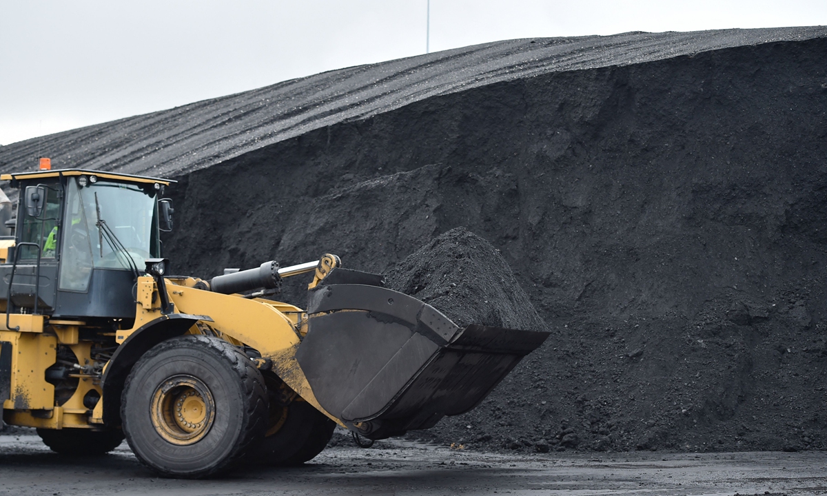 An employee drives an excavator transporting coal to the conveyor at the Emile Huchet GazelEnergie coal power plant, in Carling, France on November 29, 2022. The power station reopened on November 28 to provide additional electricity during the winter period. Photo: VCG