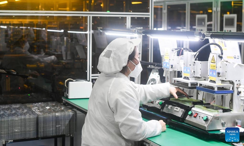 A staff member works at the smartphone production and quality control workshop of Chongqing Transsion Technology Co., Ltd. in Yubei District of southwest China's Chongqing, Dec. 3, 2022. In recent years, Yubei District of Chongqing has sped up efforts to promote the transformation of traditional industries and boost the development of intelligent manufacturing. (Xinhua/Wang Quanchao)
