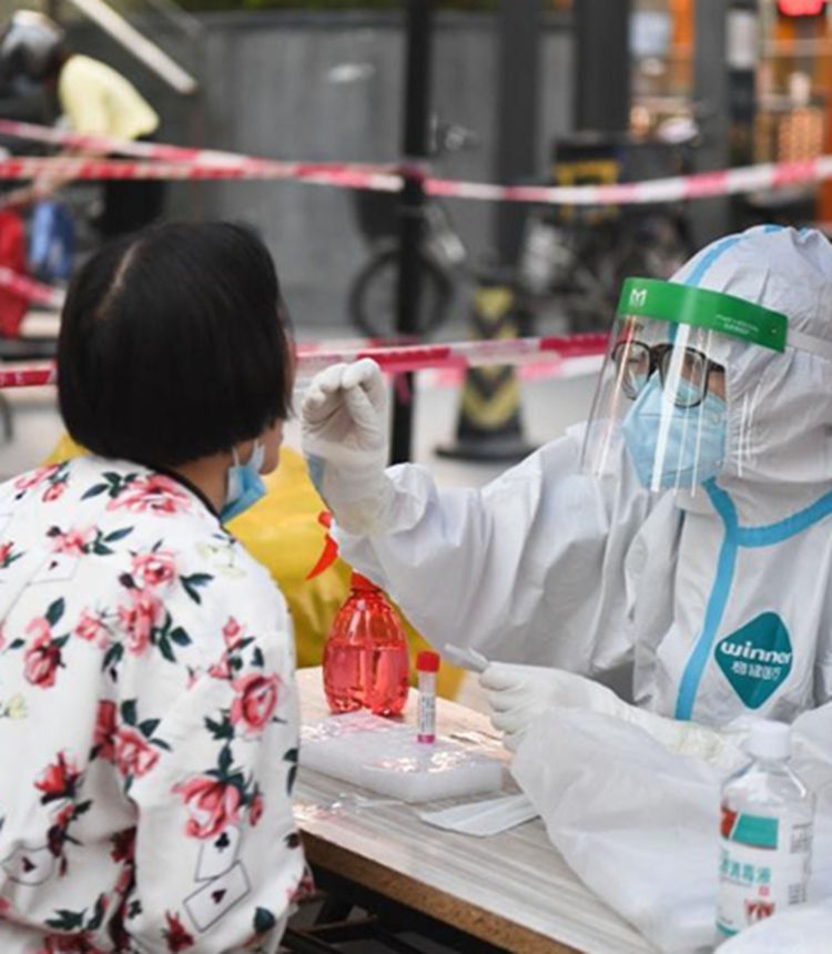 A medical worker takes a swab sample from a resident for nucleic acid test at a community in Liwan district of Guangzhou, South China's Guangdong province. Photo: Xinhua