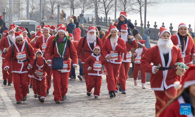 People in Santa Claus costumes participate in the Santa Run in downtown Budapest, Hungary on Dec. 4, 2022. (Photo by Attila Volgyi/Xinhua)