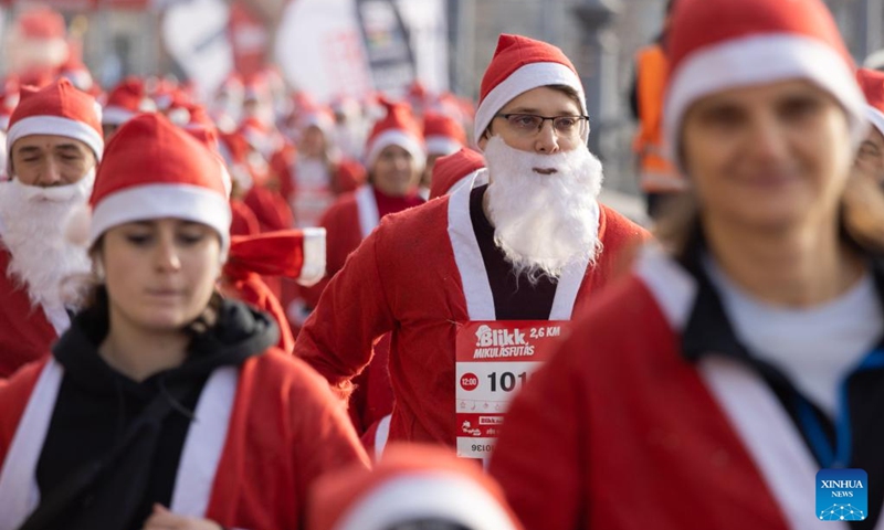 People in Santa Claus costumes participate in the Santa Run in downtown Budapest, Hungary on Dec. 4, 2022. (Photo by Attila Volgyi/Xinhua)
