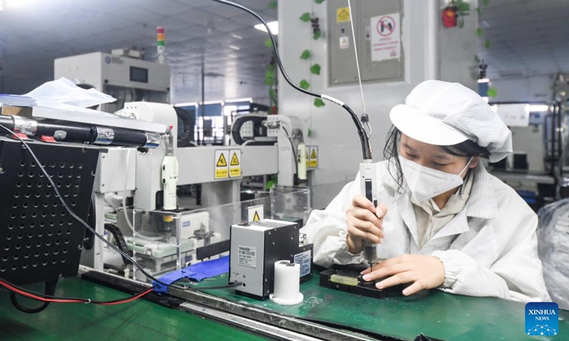 A staff member works at the smartphone production and quality control workshop of Chongqing Transsion Technology Co., Ltd. in Yubei District of southwest China's Chongqing, Dec. 3, 2022. In recent years, Yubei District of Chongqing has sped up efforts to promote the transformation of traditional industries and boost the development of intelligent manufacturing. (Xinhua/Wang Quanchao)