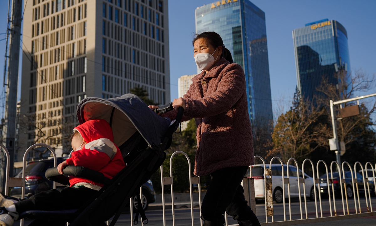 A Beijing resident out walking on December 5, 2022. Photo: IC