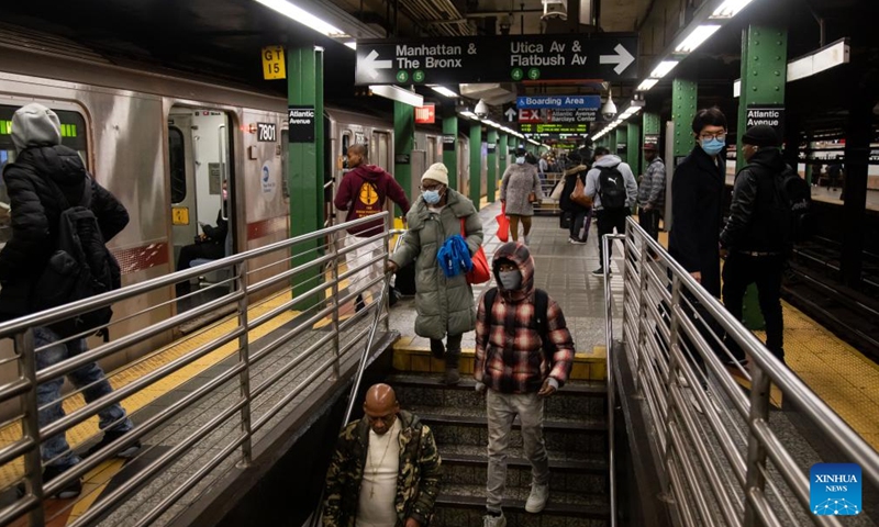 People wearing face masks are seen at a subway station in New York, the United States, on Dec. 7, 2022. The United States is experiencing surge in respiratory illnesses including COVID-19, flu and respiratory syncytial virus (RSV), worsening the strain on hospitals.(Photo: Xinhua)