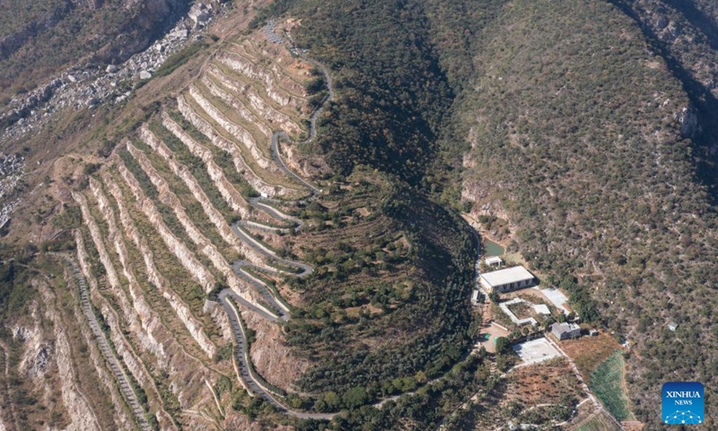 This aerial photo shows a paved road in a mining site after ecological restoration in a cycad national nature reserve in Panzhihua, southwest China's Sichuan Province, Nov. 28, 2022. The city of Panzhihua boasts China's only national-level cycad nature reserve, with over 385,000 cycad plants.(Photo: Xinhua)