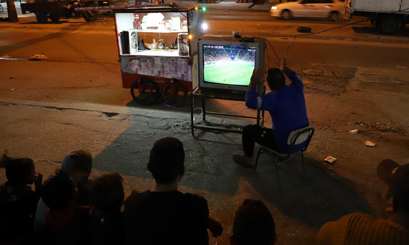People watch a televised match of the FIFA World Cup Qatar 2022 on a street in Gaza City Nov. 23, 2022.(Photo: Xinhua)