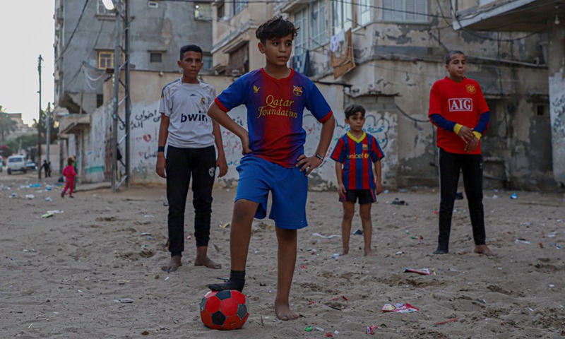 Palestinian boys play football in a street at the Shati refugee camp in Gaza City, on Nov. 30, 2022.(Photo: Xinhua)