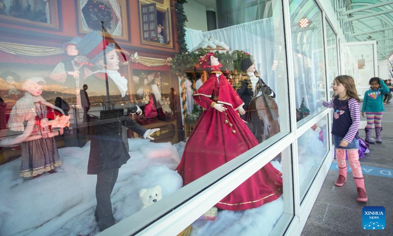 A girl looks at vintage Christmas window displays at Canada Place in Vancouver, British Columbia, Canada, on Dec. 12, 2022. The vintage Christmas window displays are now for viewing here as part of the Christmas highlights in Vancouver.(Photo: Xinhua)