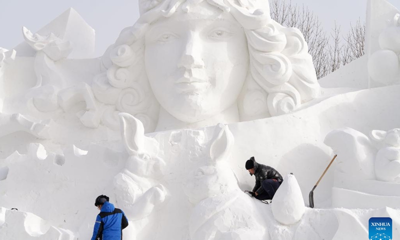 Workers work at a snow sculpture at the venue of the Sun Island International Snow Sculpture Art Exposition in Harbin, northeast China's Heilongjiang Province, Dec. 12, 2022.(Photo: Xinhua)