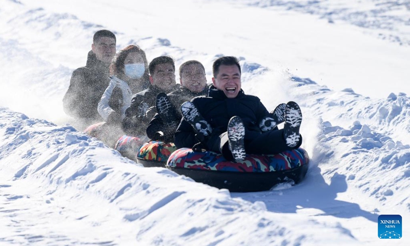 People participate in snow entertainment at a ski resort in Kazak Autonomous County of Mori, northwest China's Xinjiang Uygur Autonomous Region, Dec. 12, 2022. The 2nd snow and ice tourism carnival in Kazak Autonomous County of Mori kicked off on Monday.(Photo: Xinhua)