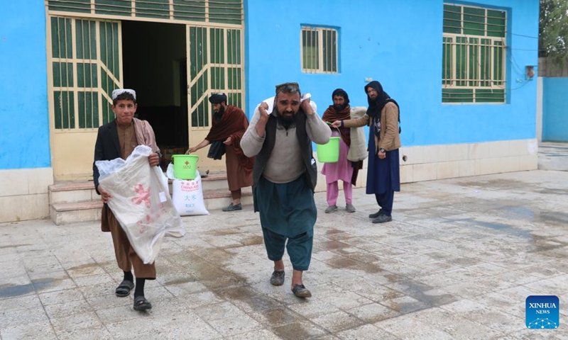Afghans receive China-donated humanitarian aid in Farah province, Afghanistan, Dec. 11, 2022. Authorities for Disaster Management and Humanitarian Affairs (DMHA) of Afghanistan's western Farah province have distributed a batch of China-donated humanitarian aid to the needy families in the provincial capital Farah city.(Photo: Xinhua)
