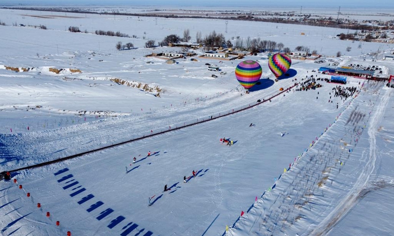 This aerial photo taken on Dec.12, 2022 shows opening ceremony of the 2nd snow and ice tourism carnival in Kazak Autonomous County of Mori, northwest China's Xinjiang Uygur Autonomous Region. The 2nd snow and ice tourism carnival in Kazak Autonomous County of Mori kicked off on Monday.(Photo: Xinhua)