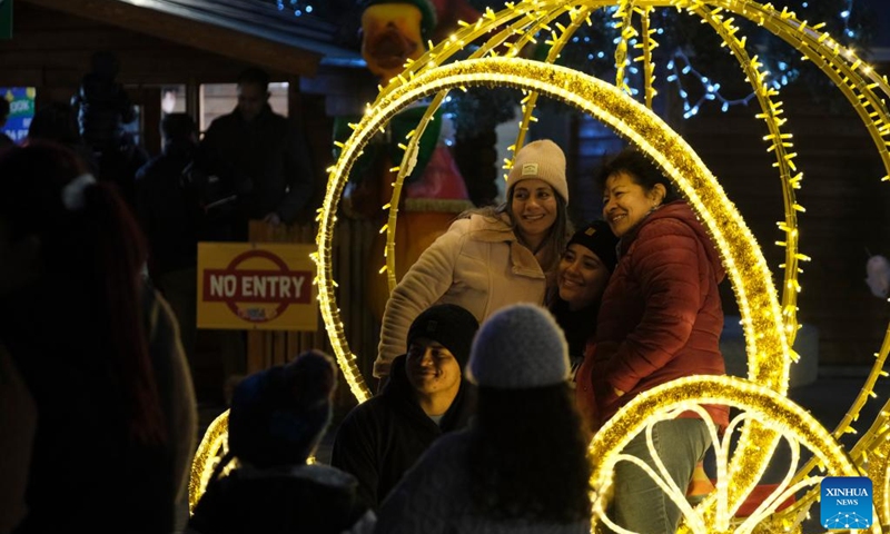 People take photos in the Triton Square decorated with Christmas lights in Valletta, Malta, Dec. 12, 2022. The Triton Square in Valletta is transformed into a fairyland to welcome the upcoming Christmas.(Photo: Xinhua)