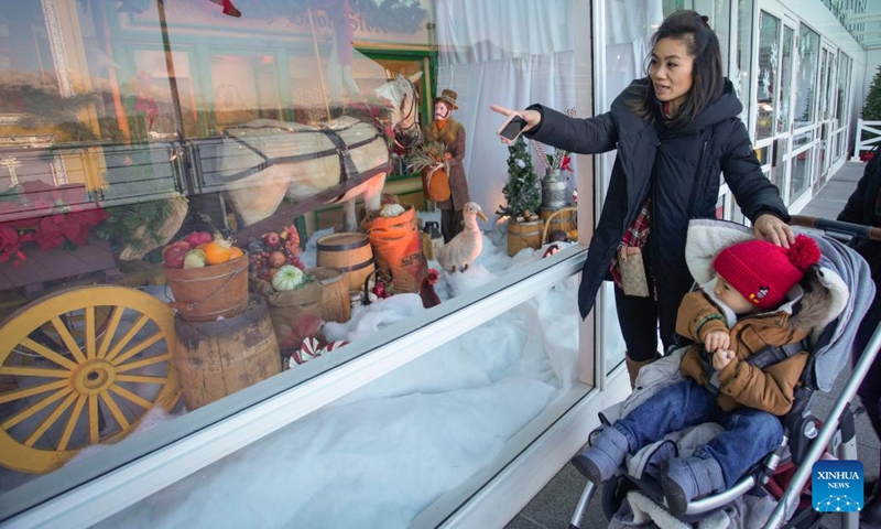 People look at vintage Christmas window displays at Canada Place in Vancouver, British Columbia, Canada, on Dec. 12, 2022. The vintage Christmas window displays are now for viewing here as part of the Christmas highlights in Vancouver.(Photo: Xinhua)