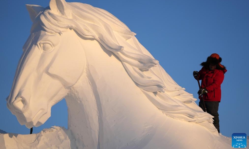 A worker works at a snow sculpture at the venue of the Sun Island International Snow Sculpture Art Exposition in Harbin, northeast China's Heilongjiang Province, Dec. 11, 2022.(Photo: Xinhua)