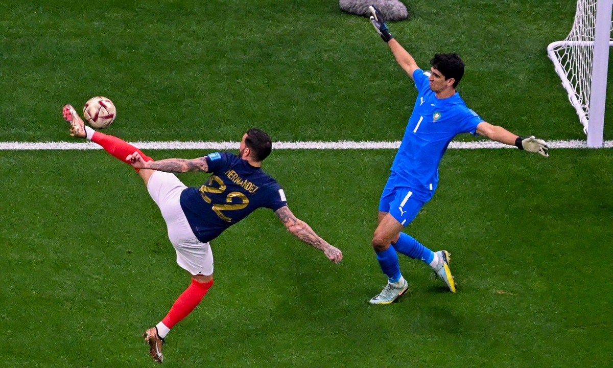 France's Theo Hernandez (left) scores a goal during the World Cup semifinal match between France and Morocco in Al Khor, Qatar on December 14, 2022. Photo: VCG