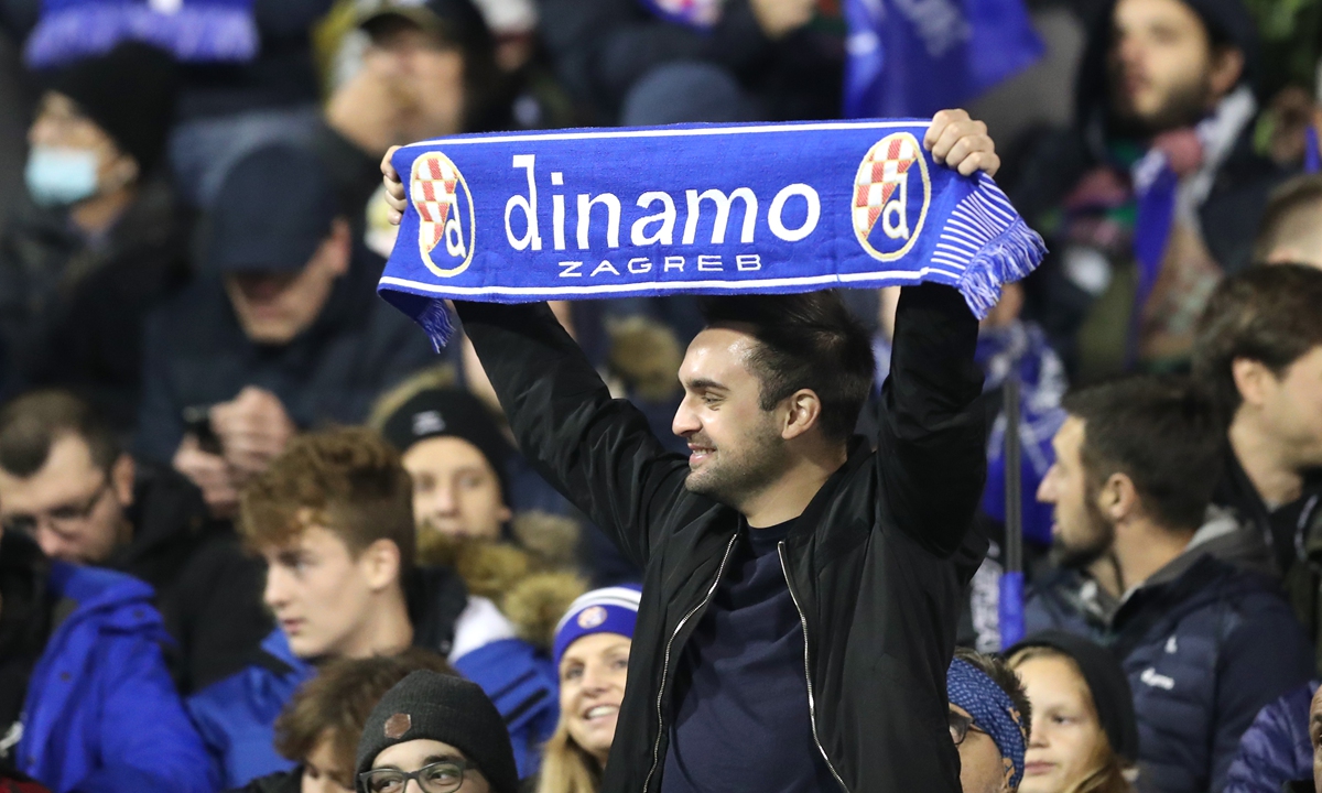 A fan holds a Dinamo Zagreb scarf before a match at Maksimir Stadiumin Zagreb, Croatia.  Photo: VCG