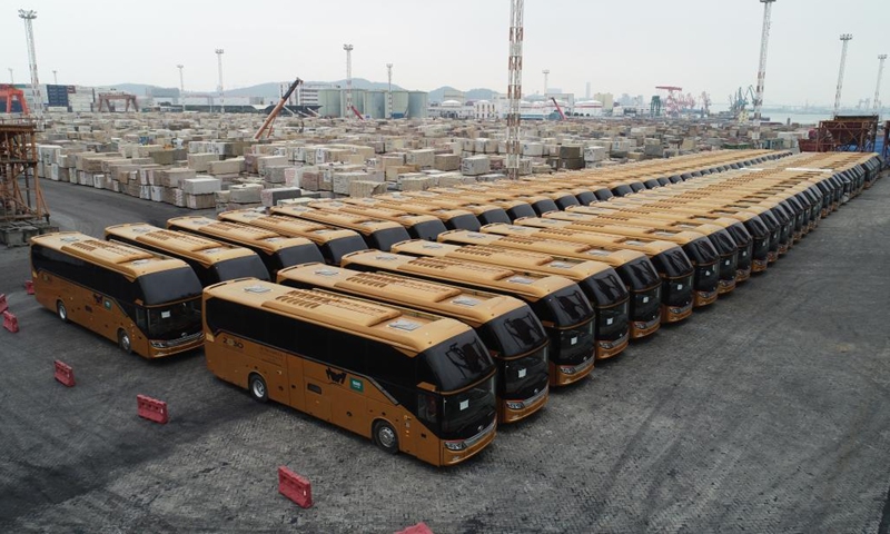 This aerial photo taken in April 2020 shows buses produced by Xiamen King Long United Automotive Industry Co., Ltd. for export at a port in Xiamen, southeast China's Fujian Province. (Photo: Xinhua)