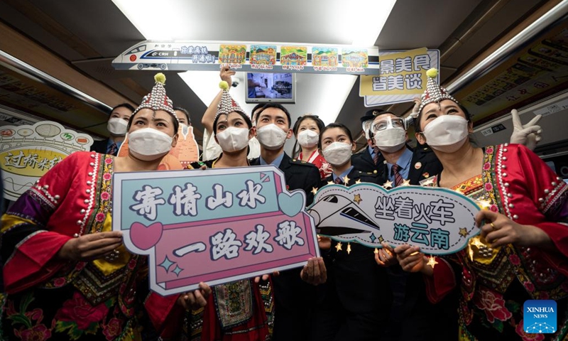 Conductors pose for a photo on a trial running train of Mile-Mengzi high-speed railway in southwest China's Yunnan Province, Dec. 14, 2022. The 107-km railway will link the cities of Mile and Mengzi, both located in Yunnan's Honghe Hani and Yi Autonomous Prefecture. Passenger trains operating on the railway are due to travel at 250 km per hour.(Photo: Xinhua)