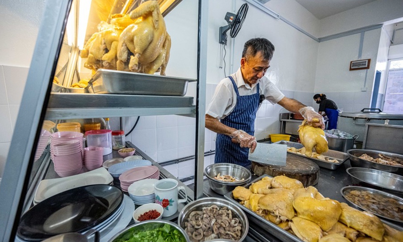 Andrew Wong Hin Hau prepares chicken for Hainan chicken rice in Kota Kinabalu in Sabah, Malaysia, Dec. 3, 2022.(Photo: Xinhua)