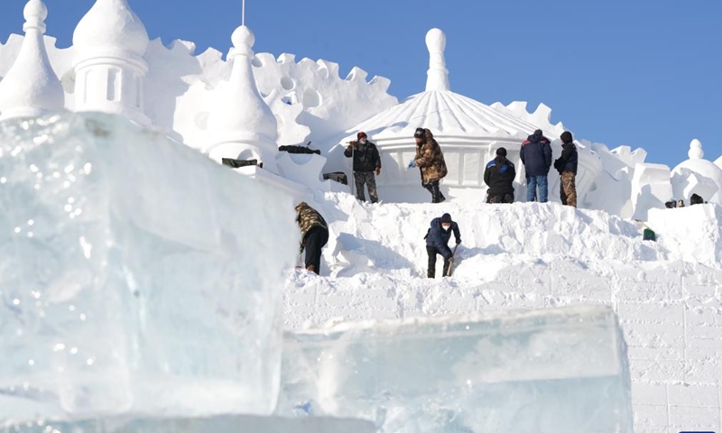 Staff members work on a gigantic snow sculpture for the upcoming 35th Taiyangdao Island International Snow Sculpture Expo in Harbin, northeast China's Heilongjiang Province, Dec. 18, 2022.(Photo: Xinhua)