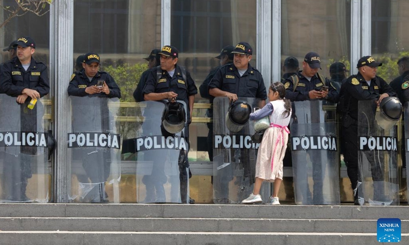 Police officers stand guard in Lima, Peru, Dec. 14, 2022. Peru declared a nationwide 30-day state of emergency on Wednesday in a bid to quash sometimes violent protests in various regions, Defense Minister Alberto Otarola said.(Photo: Xinhua)