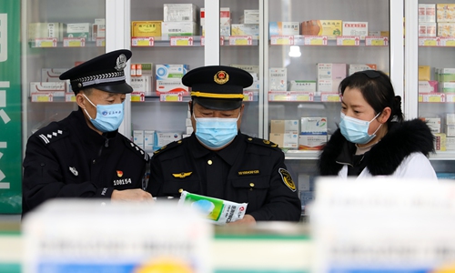 Officials in East China's Jiangsu Province conduct an on-site inspection of a pharmacy on December 14, 2022. Photo: cnsphoto