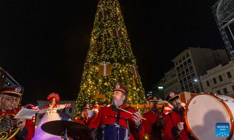 The Big Band of the Municipality of Athens plays Christmas songs at a Christmas event at Omonoia square in Athens, Greece, on Dec. 18, 2022. (Xinhua/Marios Lolos)