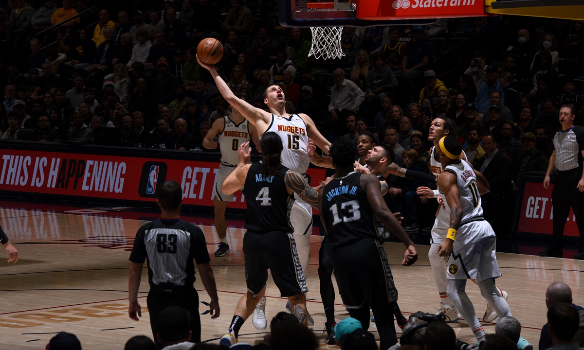 Nikola Jokic of the Denver Nuggets drives to the basket against the Memphis Grizzlies on December 20, 2022 in Denver, the US. Photo: AFP