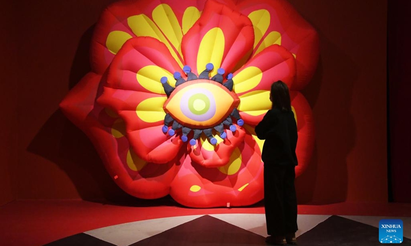A visitor views an art installation at Blooming Echoes, an exhibition featuring the combination of sound and modern art, at the Times Art Museum in Beijing, capital of China, Dec. 21, 2022.(Photo: Xinhua)