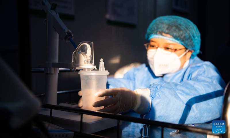 A medical worker prepares inhalable COVID-19 vaccine doses at a community health service center in Tianxin District of Changsha, central China's Hunan Province, Dec. 22, 2022. Inhalable COVID-19 vaccines are available at many vaccine sites in Changsha now as the epidemic continues to rage. China has approved the inhalable vaccine for emergency use among populations aged 18 and above who had received two doses of traditional vaccines, but not within the previous six months.(Photo: Xinhua)