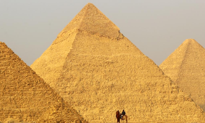 Tourists ride horses at the Giza Pyramids scenic spot in Giza, Egypt, on Dec. 22, 2022.(Photo: Xinhua)