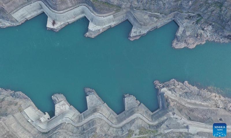 This aerial photo taken on Nov. 24, 2022 shows the water outlet of the Baihetan hydropower station, which straddles the provinces of Yunnan and Sichuan in southwest China. The Baihetan hydropower station, the world's second-largest in terms of total installed capacity, went fully operational Tuesday in the upper section of the Yangtze River in southwest China, according to China Three Gorges Corporation.(Photo: Xinhua)
