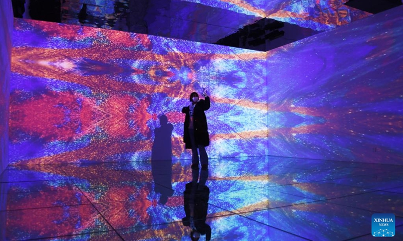 A visitor views art installations at Blooming Echoes, an exhibition featuring the combination of sound and modern art, at the Times Art Museum in Beijing, capital of China, Dec. 21, 2022.(Photo: Xinhua)