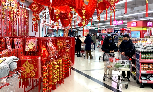 People shop in a local supermarket in Fuzhou, East China's Fujian Province on December 25, 2022. With the approach of the New Year, business at brick-and-mortar sales outlets in Fuzhou is booming. Photo: cnsphoto