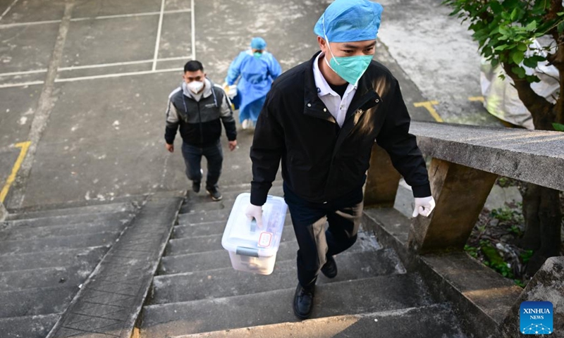 Medical workers walk to provide COVID-19 vaccination for senior residents at a community in Wenchang, south China's Hainan Province, Dec. 23, 2022. The door-to-door services have been offered to help the elderly get COVID-19 vaccinations in the city of Wenchang. (Xinhua/Pu Xiaoxu)