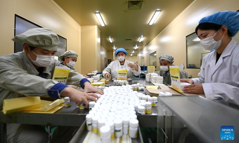 Workers pack medicine at a pharmaceutical company in north China's Tianjin, Dec. 24, 2022. Pharmaceutical production lines in Tianjin are running at full capacity, increasing the market supply of medicine for COVID-19 symptoms. (Xinhua/Zhao Zishuo)