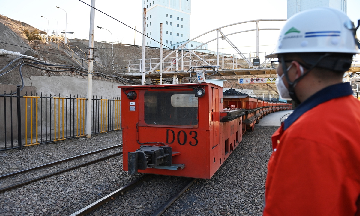 A staff member observes the operation of a driverless rail vehicle at a local mine in Jinchang, Northwest China's Gansu Province on December 26, 2022. The company has adopted the 