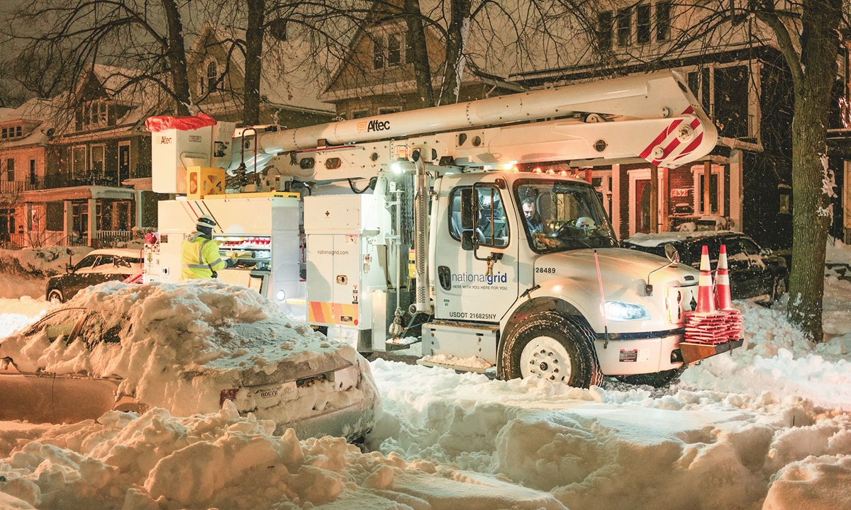 National Grid technicians work in Buffalo, New York, on December 26, 2022. Emergency crew in New York was scrambling to rescue marooned residents from what authorities called the 