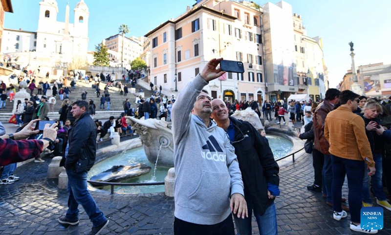 Tourists pose for photos at the Piazza di Spagna on Christmas Day in Rome, Italy, on Dec. 25, 2022. Italy is expected to have its warmest holiday season in at least 50 years, according to meteorologists, more anomalous weather in a year filled with unusual weather patterns. (Xinhua/Jin Mamengni)