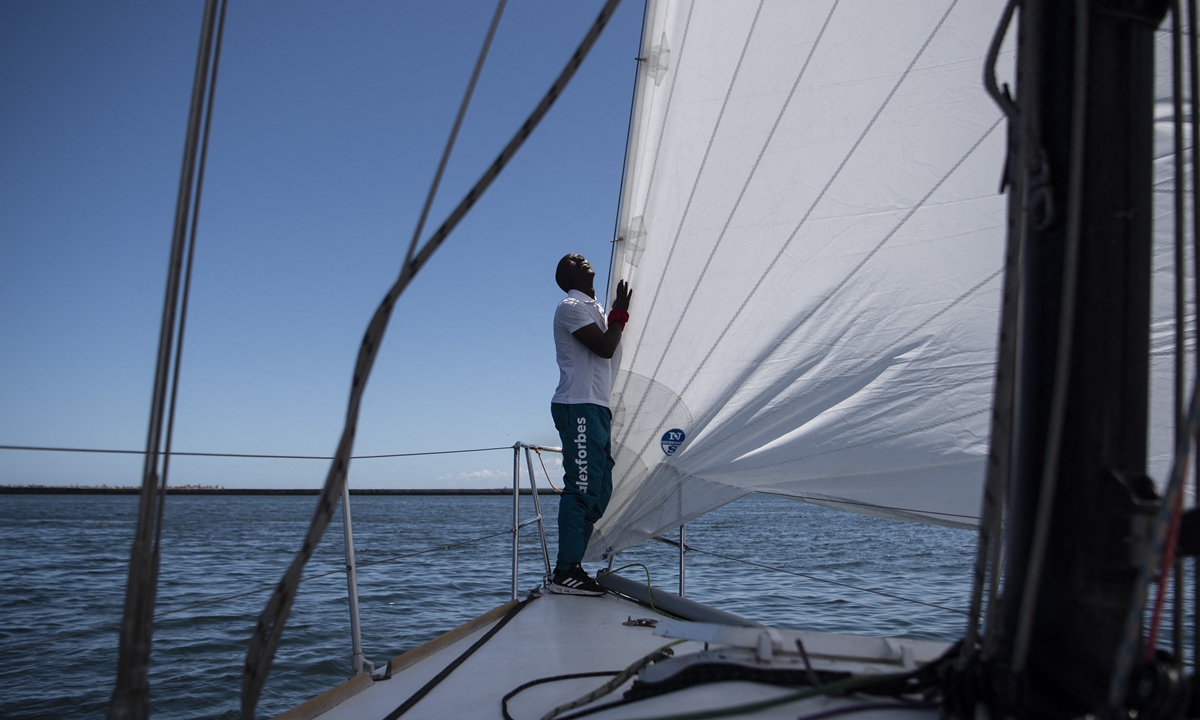 A member of the ArchAngel yacht crew adjusts the sail. File photos: AFP