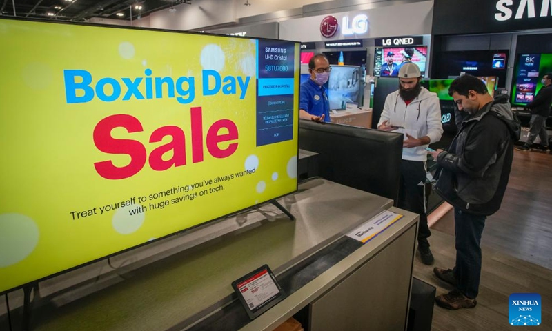 Customers check on deals inside an electronics store during the Boxing Day sale in Vancouver, British Columbia, Canada, on Dec. 26, 2022. Boxing Day is one of the biggest shopping days in Canada.(Photo: Xinhua)