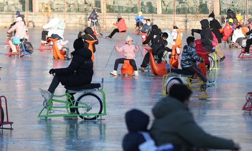 People play on an ice rink at a park in Beijing on December 29, 2022. Photo: cnsphoto