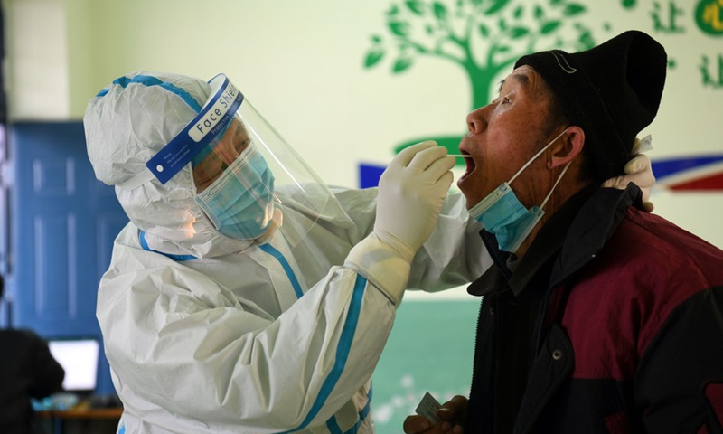 A medical worker collects a swab sample from a resident at a COVID-19 testing site in Baiwangzhuang Village of Jingxing County, Shijiazhuang, capital of north China's Hebei Province, Jan 20, 2021. Photo: Xinhua
