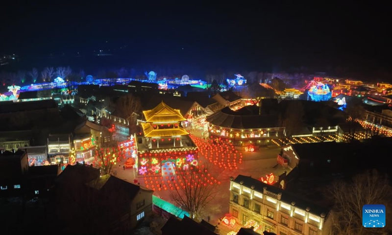 This aerial photograph, taken on December 31, 2022, shows an image of a lantern display in Shenyang, Liaoning Province in northeastern China.  A lantern display to greet the upcoming Spring Festival started here on December 30, 2022.  Covering more than 20,000 square meters, the lantern show is a visitor attraction, with more than 70 large lighting installations illuminating the city's night sky.  (Xinhua/Yang Qing)