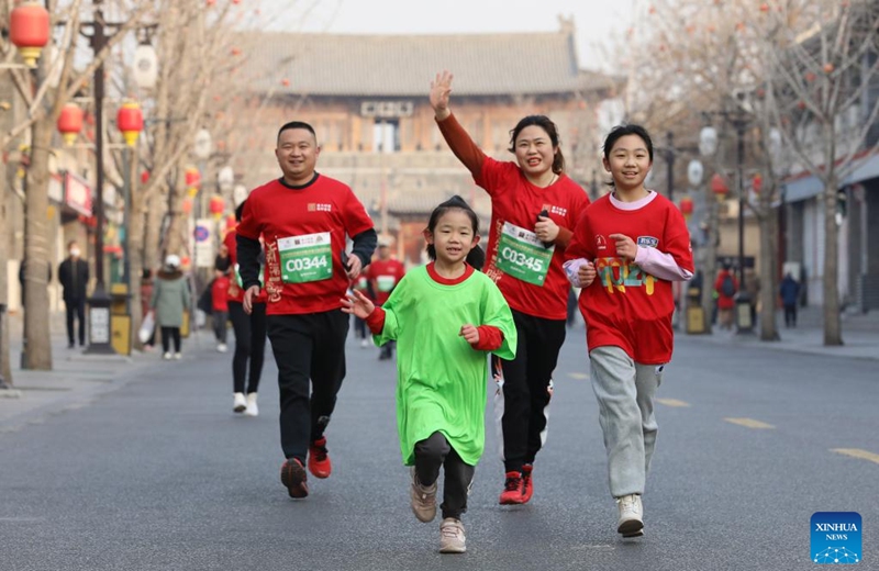 People take part in a running activity to celebrate the New Year in Shijiazhuang, north China's Hebei Province, Jan. 1, 2023. (Photo by Liang Zidong/Xinhua)