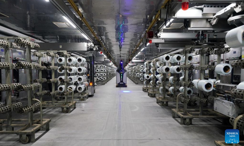 An intelligent unmanned vehicle conveys fiberglass products at a glass products company in Shahe City, north China's Hebei Province, Jan. 6, 2023. Glass products companies in Shahe have stepped up production to guarantee the completion of orders from domestic and foreign customers at the beginning of the new year. (Xinhua/Mu Yu)